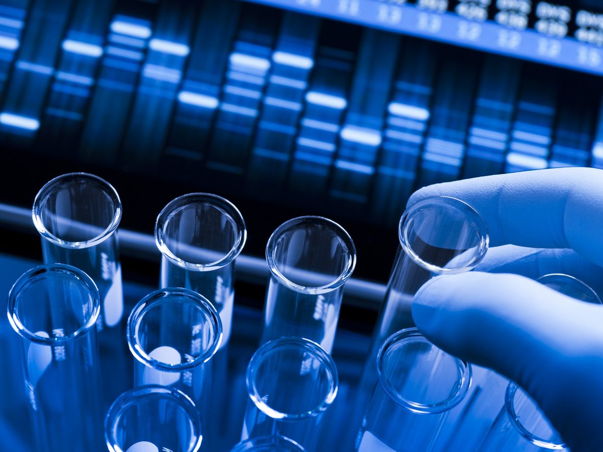 Researcher hand handling test tubes in the lab