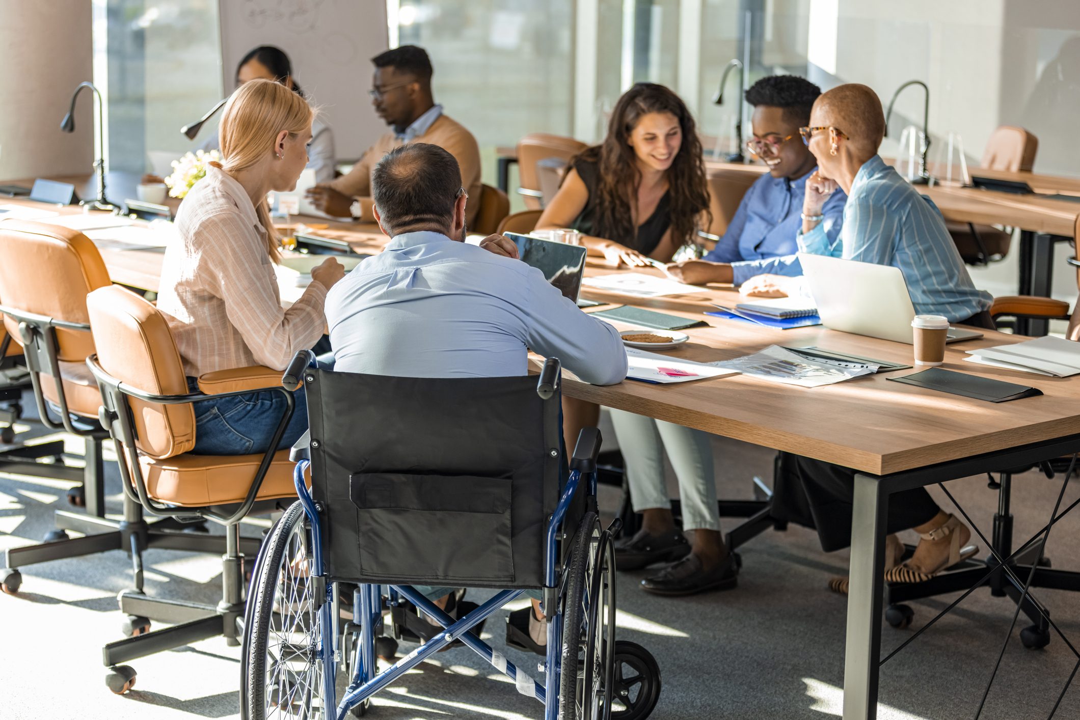 A diverse group of people discussing around a table