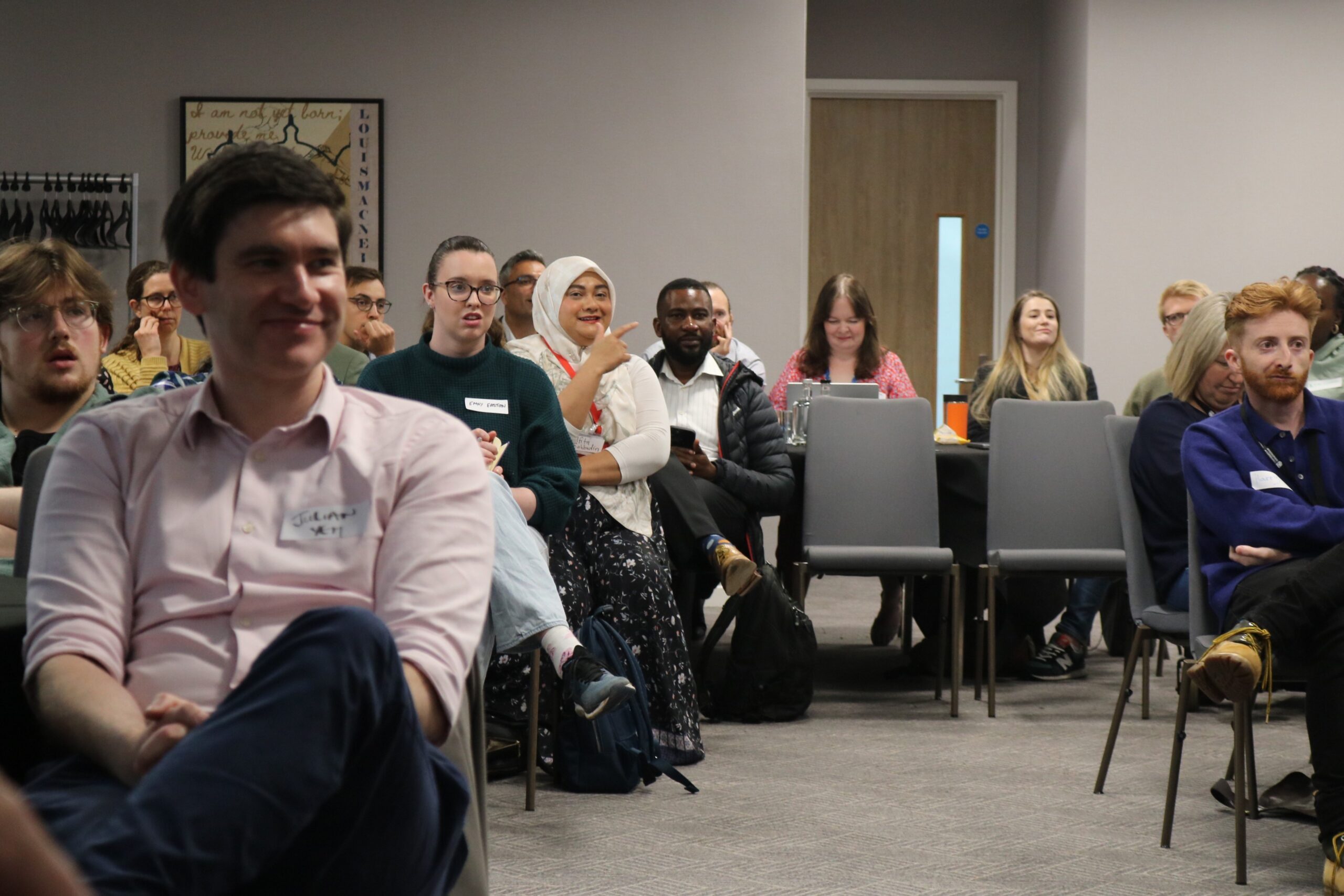 Attendees sitting in conference room and interacting during a Q&A