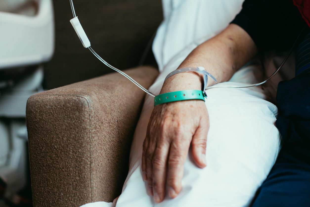Cancer patient in hospital receiving treatment via intravenous system
