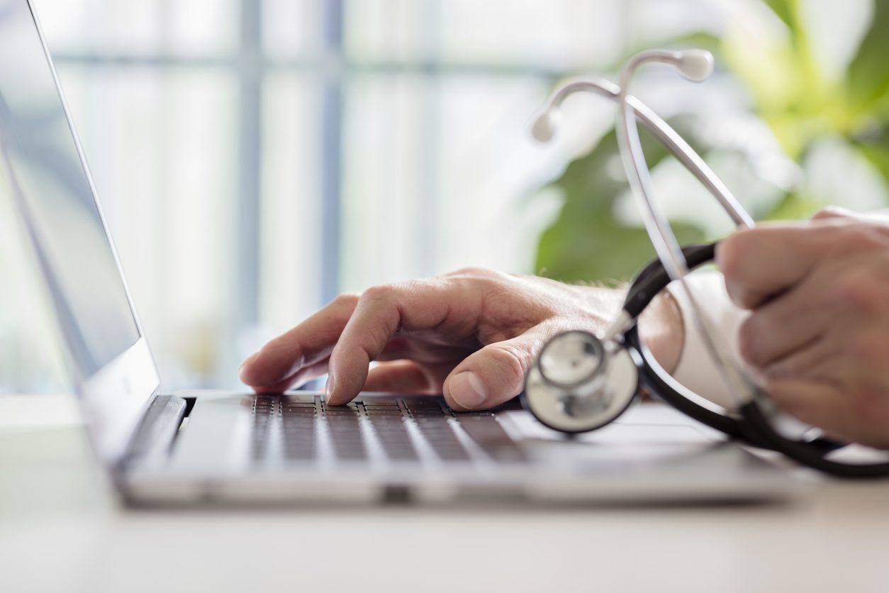 Doctor checking patient data on a laptop