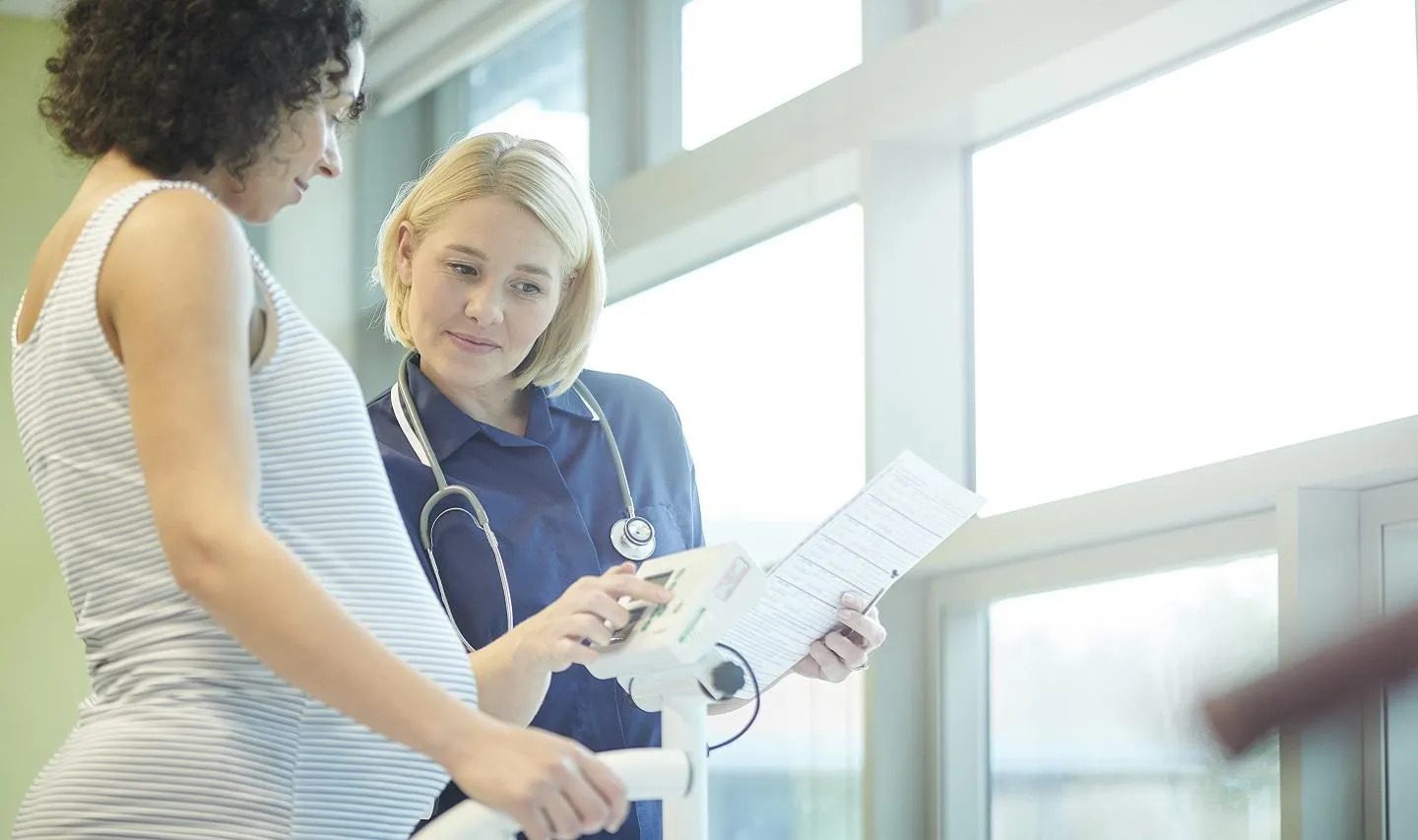 Pregnant woman speaking with healthcare professional