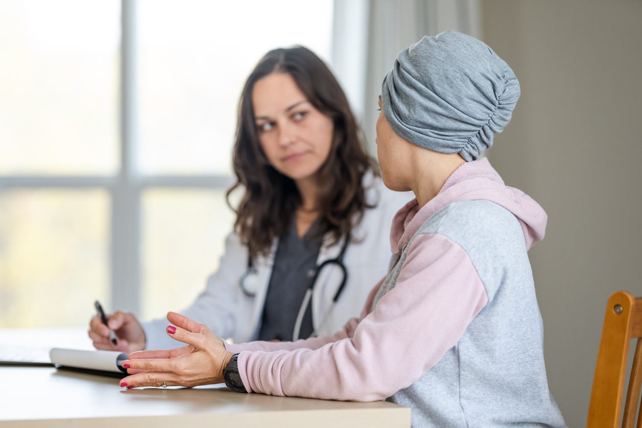 Woman with cancer speaking with doctor