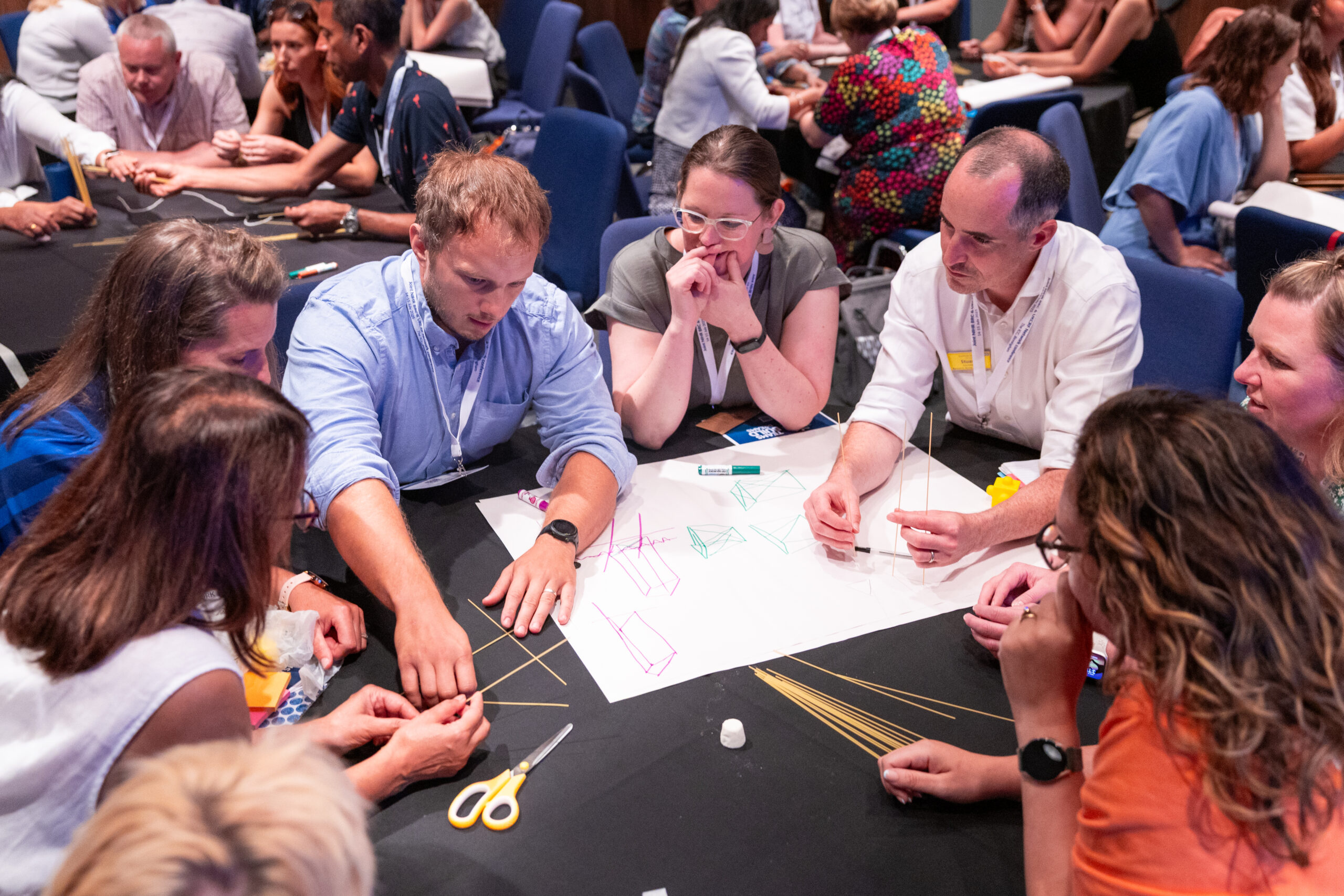 Attendees working together at a table during a workshop