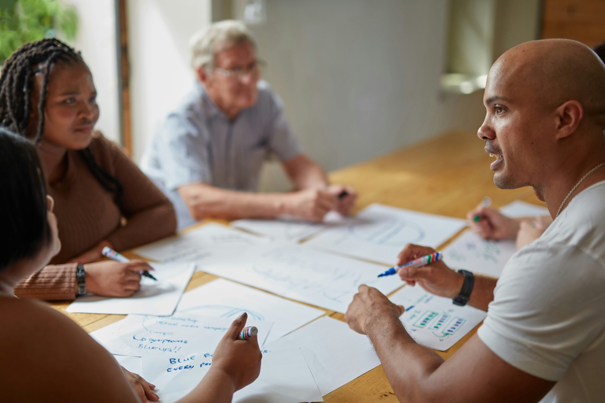 Group of people brainstorming around a table