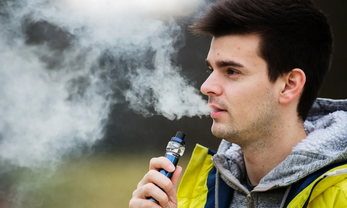 Young man vaping