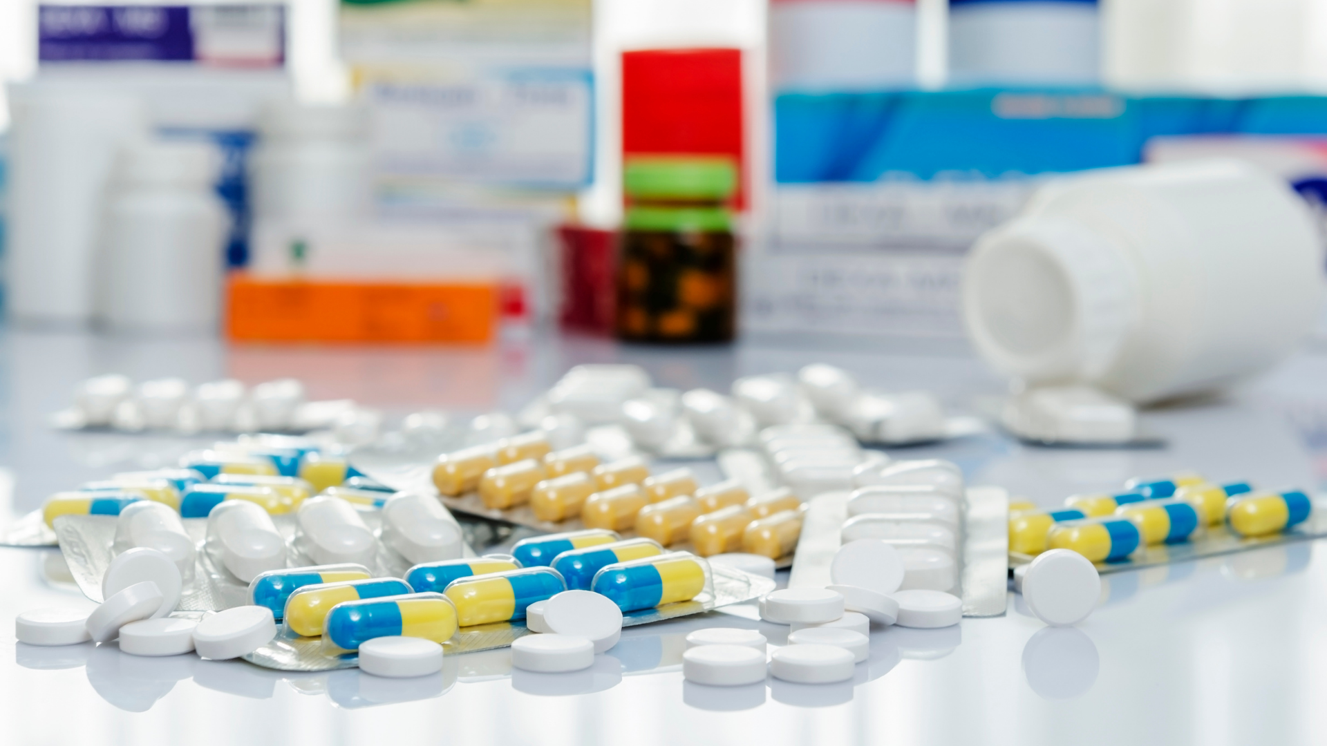 Several antibiotic pills and containers on a table
