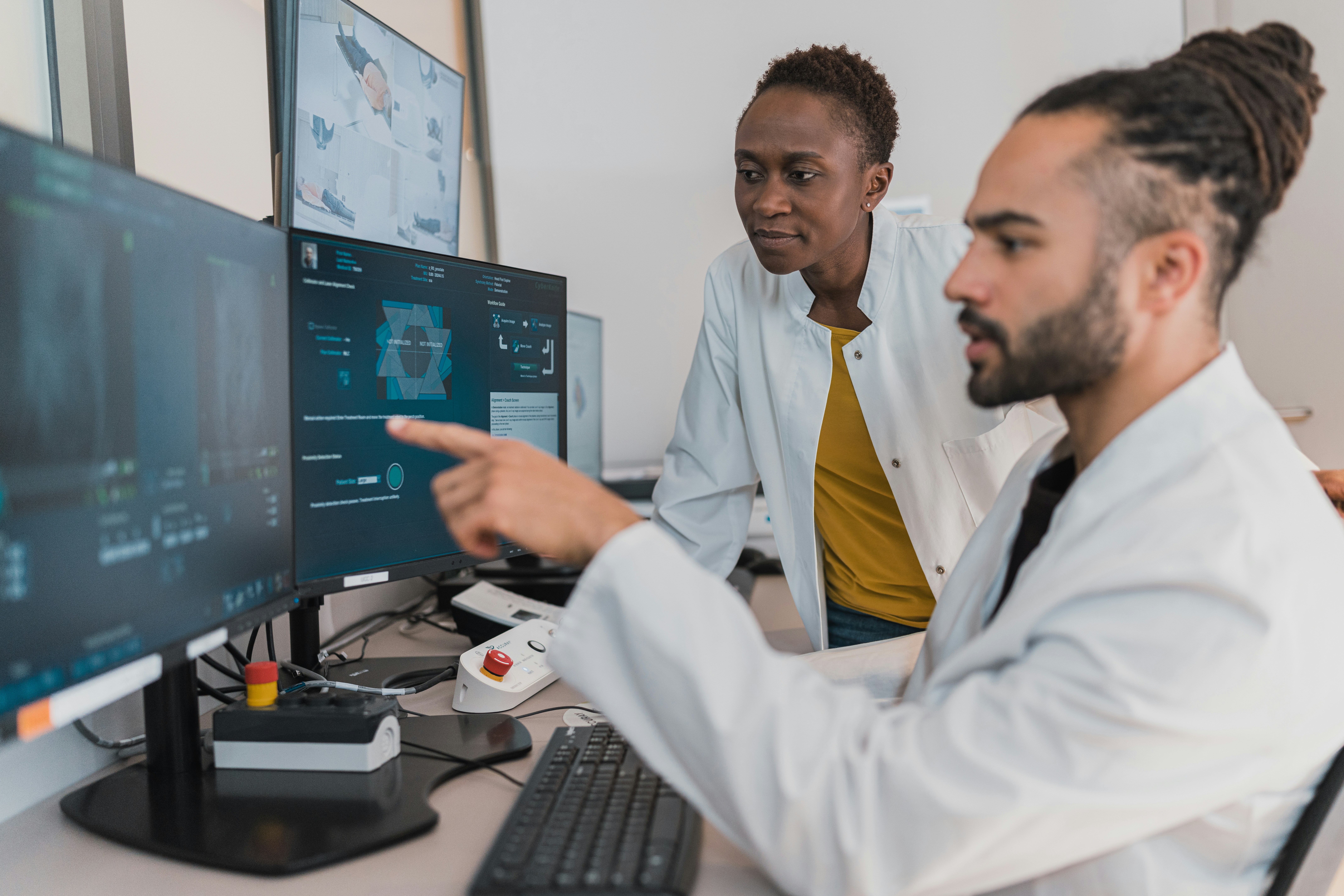Healthcare professionals looking at computers with health data