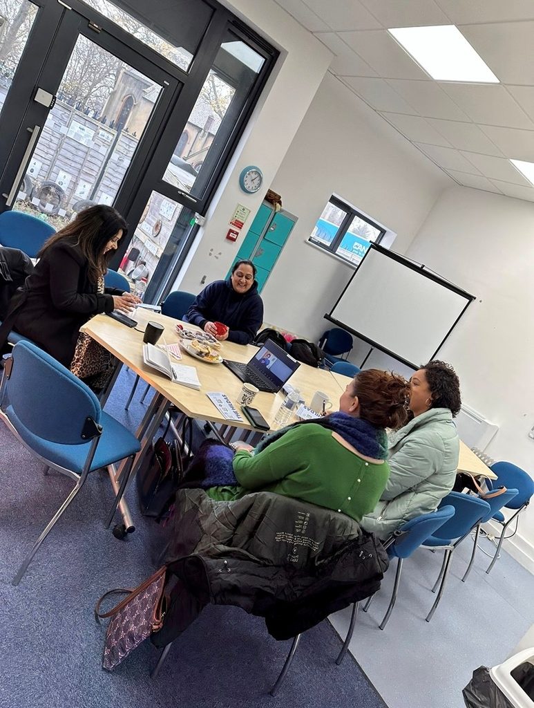 Hildas group meeting, with women sitting around a table and discussing