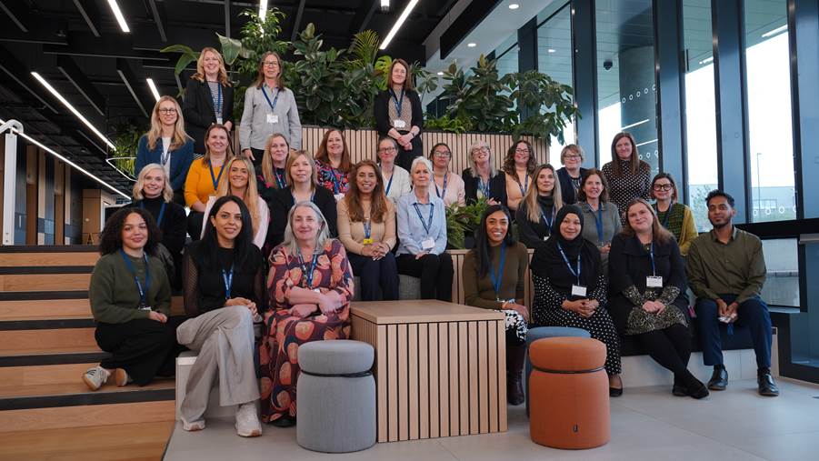 NIHR infrastructure managers and key staff sitting on a staircase
