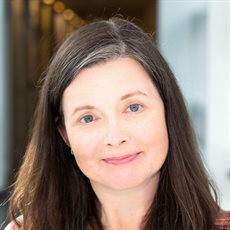 marie falahee smiling in a corridor