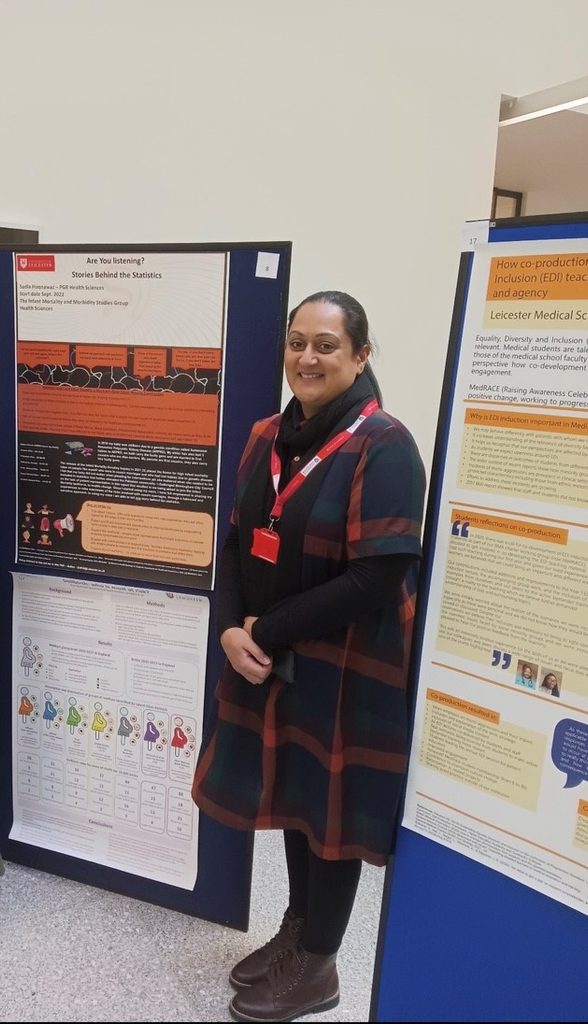Woman standing next to her research poster at a conference