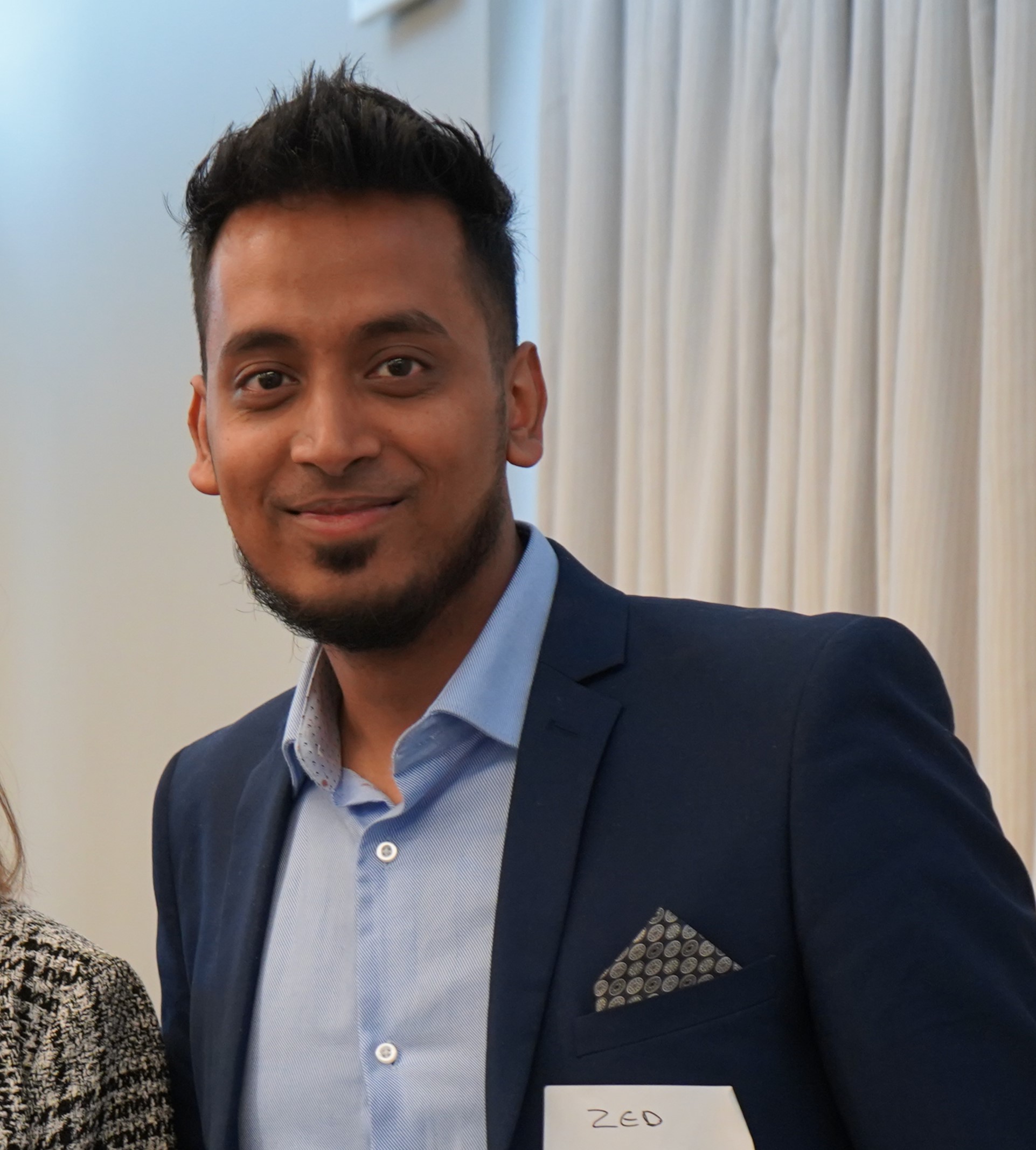 zohur miah smiling at a conference